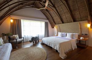 a bedroom with a large bed and a large window at Nay Palad Hideaway - All Inclusive Stay in General Luna