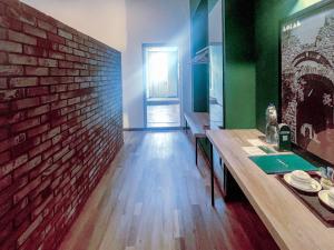a dining room with a brick wall and a table at LOKAL Rooms x Murree Kashmir Point in Murree