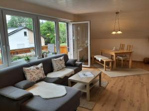 a living room with a couch and a table at Ferienwohnung Marion in Wallenborn