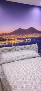 a bedroom with a large bed with a view of a city at Dantonarooms in Naples
