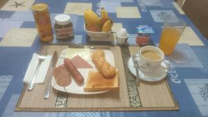 a table with a plate of food and a cup of coffee at Villa Shangri-La in Dumaguete