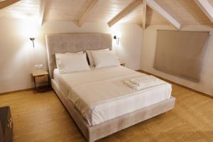 a bedroom with a large white bed in a room at La villa events in Amalias +6 photos