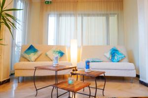 a living room with a couch and two tables at Hotel Athena B&B in Gabicce Mare