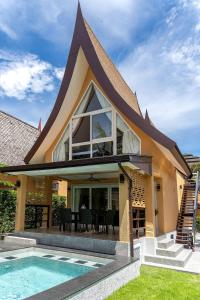 a house with a swimming pool next to a house at Villa of Siam in Ko Chang