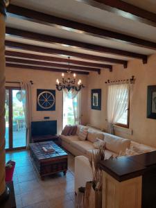 a living room with a couch and a chandelier at Casa dell'Arte Hotel of Arts & Leisure in Torba