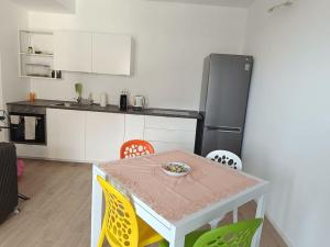 a kitchen with a table and chairs and a refrigerator at Eden house in Lecco