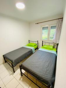 a room with two beds and a window at Koker's Place in Thessaloniki +70 photos