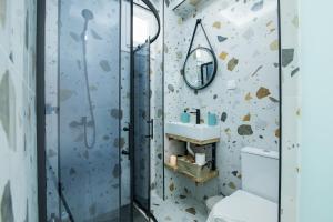 a bathroom with a shower with a toilet and a sink at Anais Luxury Living - Green by CorfuEscapes in Marathias