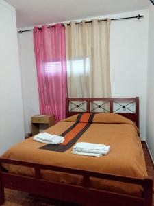 a bedroom with a bed with two towels on it at Nefama Pensao in Ourique