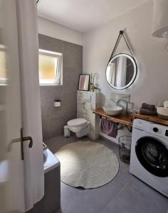łazienka z umywalką i pralką w obiekcie Apartman Teo w Medulinie