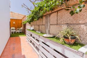 a garden with plants on a brick wall at Villa Neon Tenerife in Arona
