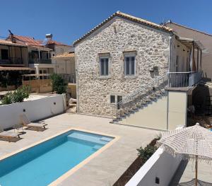 a house with a swimming pool next to a building at Dizen Spartochori in Meganisi