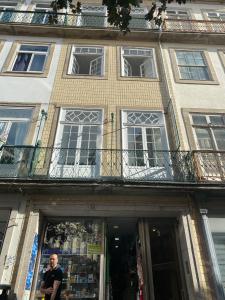 a man standing in front of a building at Casa Augusta 3 in Braga