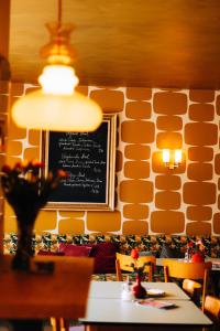 a dining room with a chalkboard on a wall at Molo Rouge in Wunsiedel