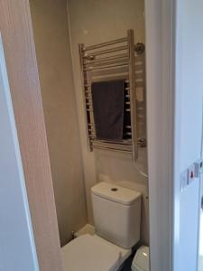 a small bathroom with a toilet and a mirror at The Posh Bothy Spean Bridge in Roybridge