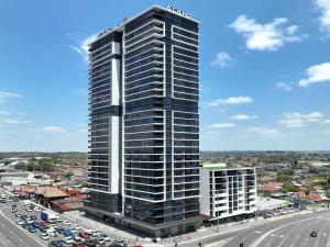 a tall building in a city next to a highway at Liverpool Brand new 2 Br Apt City View Parking in Liverpool
