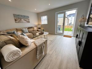 a living room with a couch and a table at Seagrass in Sandown