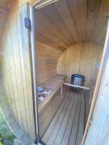 an inside view of a wooden sauna with a stove at Little Breoke in Lostwithiel