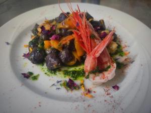 a white plate with a dish of food on it at Hotel Ferretti in Diamante