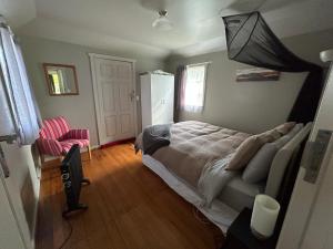 1 dormitorio con 1 cama con sombrilla encima en Conway River View Cottage For 2, en Cheviot