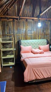 a bedroom with two beds and racks of wine racks at Para para cafe & cottage in Berastagi