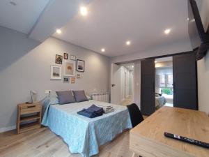 a bedroom with a bed and a table in it at Rivero Aviles Home in Avilés