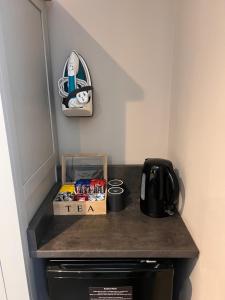 a counter top with a tea box on top of a stove at South Lawn Hotel in Lymington