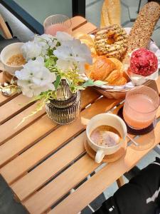 a table with pastries and cups of coffee and flowers at Best Studio for Business & Family Super Fast WI-FI in Plovdiv