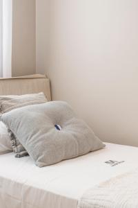 a bed with two pillows on top of it at Apartamentos Martalia Áticos Deluxe in Ronda