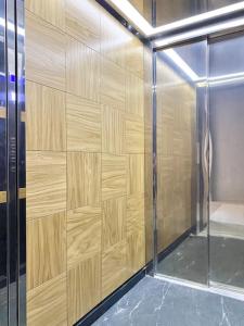 a wooden wall in a shower with a glass door at Best Studio for Business & Family Super Fast WI-FI in Plovdiv