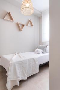 Łóżko lub łóżka w pokoju w obiekcie Apartamentos Martalia Áticos Deluxe