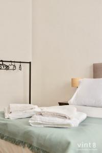 a bed with white towels sitting on top of it at Apartamento do Arquinho II- by VinteOito in Amarante +39 photos