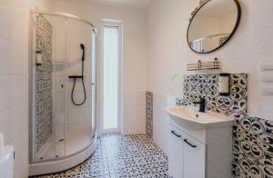 a bathroom with a shower and a sink and a mirror at Mikro Aparty bezpłatny parking in Wrocław +65 photos