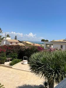 a garden with flowers and plants and a building at Archiammare Sea in Reitani