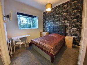 a bedroom with a bed and a brick wall at Palm Beach Hotel in Bournemouth