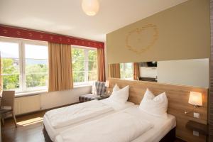 a hotel room with two beds and a window at Dollinger in Innsbruck