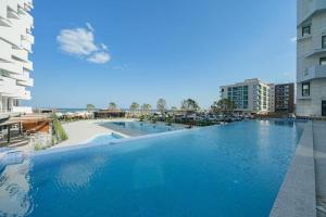 a large swimming pool in the middle of a building at Nereide Apartament - Complex Infinity Pool in Mamaia Sat/Năvodari