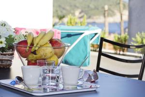 a tray with a bowl of fruit on a table at Apartments Ragusa Palace 1 Djardin in Dubrovnik