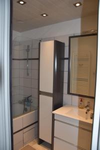 a kitchen with a refrigerator and a sink and a tub at App avec garage Au Pied De Pistes in La Plagne Tarentaise