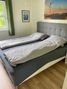 two beds in a bedroom with a bed frame at Leilighet med flott uteplass in Ulefoss