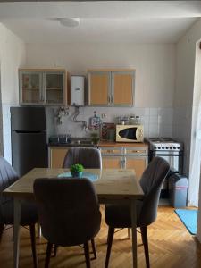 a kitchen with a wooden table and chairs in it at TA&TI in Ohrid