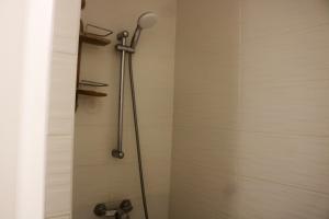 a shower with a shower head in a bathroom at Appartement d'une chambre avec balcon amenage et wifi a Le Gosier a 1 km de la plage in Le Gosier