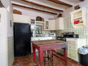 a kitchen with a black refrigerator and a table at El Nido Lane Tesuque, 1 Bedroom, Sleeps 2, Private Yard, WiFi, Washer/Dryer in Santa Fe
