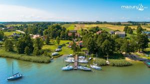an aerial view of boats docked in a river at Mazury Home in Giżycko