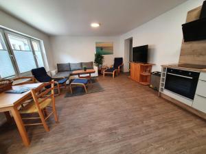 a living room with a couch and a table and chairs at Ferienwohnungen Wassergrundstück Malchow in Malchow