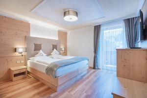 Postel nebo postele na pokoji v ubytování Hotel Ciamp