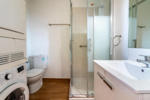 a bathroom with a toilet and a sink and a shower at Flatguest Triana urbano in Las Palmas de Gran Canaria