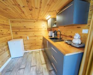 a kitchen with wooden walls and a wooden floor at Pavlonyaguestfarm in Marmaris