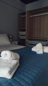 a bedroom with a bed with towels on it at Thelxis Room in Nydri