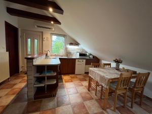 una cucina e una sala da pranzo con tavolo e sedie di Solar Apartman a Vonyarcvashegy